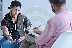 Arabic boy talking to his curator photo