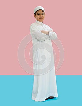 Arabic boy in traditional clothes on blue and pink background