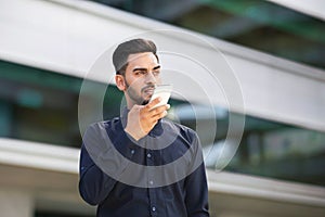 Arabic Business Man Using Voice Search Application On Smartphone Outdoors