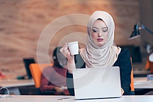 Arabic business woman wearing hijab,working in startup office.