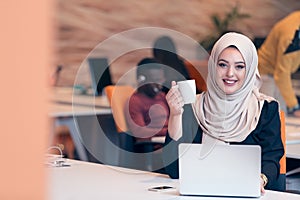 Arabic business woman wearing hijab,working in startup office.