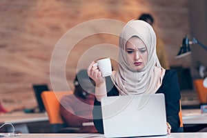Arabic business woman wearing hijab,working in startup office.