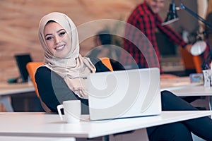 Arabic business woman wearing hijab,working in startup office.