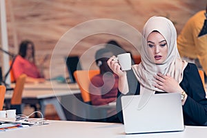 Arabic business woman wearing hijab,working in startup office.