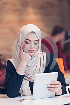 Arabic business woman wearing hijab,working in startup office.