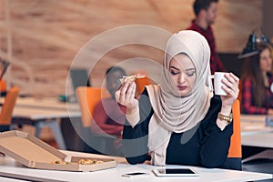 Arabic business woman wearing hijab,working in startup office.