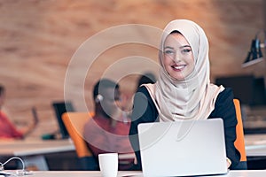 Arabic business woman wearing hijab,working in startup office. photo