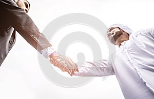 Arabic businessman giving an handshake to his business partner