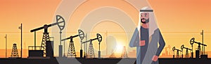 Arabic businessman over pumpjack petroleum production trade oil industry concept pumps industrial equipment drilling rig