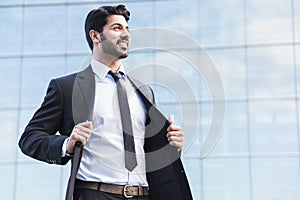 Arabic businessman or worker standing in suit near office building