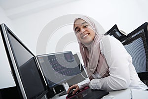 Arabic creative professional  working at home office on desktop computer