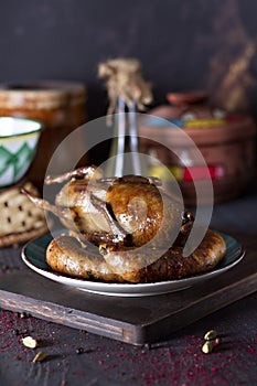 Arabic cuisine; Egyptian traditional stuffed pigeon or `Hamam Mahshi` dish. Served with cooked Freekeh, pigeon soup.