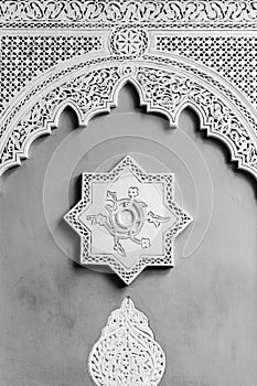 Arabic decoration of a wall with an eight-point star and a bow in the socket. Black and white image