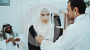 Arabic Doctor Checking Heartbeat a Muslim Woman