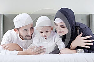 Arabic family use cellphone in bedroom