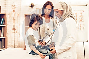 Arabic Female Doctor Checking Blood Pressure Boy