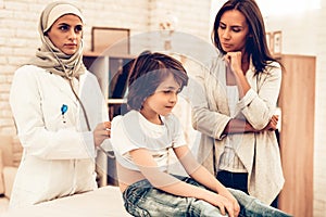 Arabic Female Doctor Examining a Little Boy