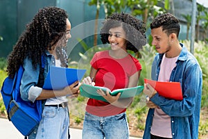 Arabic female student talking with international young adults