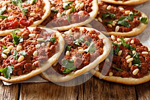 Arabic food Esfiha mini pizza with meat and pine nut closeup. Horizontal