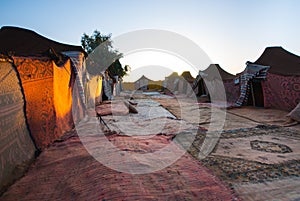 Arabic haimas camp with carpets at dawn