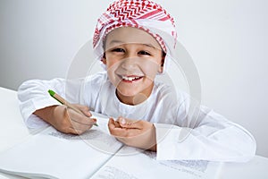 Arabic little boy doing homework