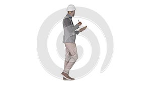 Arabic man in casual clothes and hard hat writing down checklist on white background.