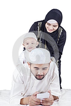 Arabic man with cellphone and his family