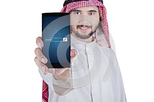 Arabic man displaying www text on cellphone