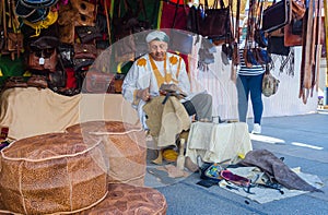 Arabic man making shoes in a market