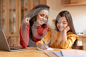 Arabic Mom And Daughter Near Laptop Doing Homework Together Indoor