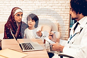 Arabic Mother with Son at Doctor`s Appointment