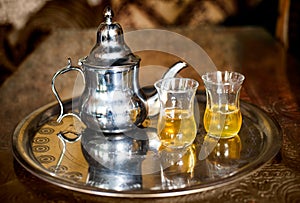 Arabic nana mint tea with metal tea pot and glasses