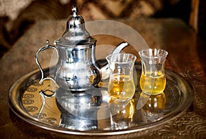 Arabic nana mint tea with metal tea pot and glasses photo