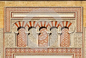 Arabic patterns on the gate Puerta de San Ildefonso in moorish style, walls of the ancient Mezquita, Cordoba photo