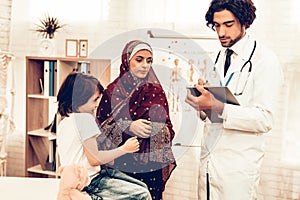 Arabic Pediatrician Appointment Mom with Sick Son. Confident Muslim Male Doctor. Hospital Concept. Healthy Concept. Pediatrician
