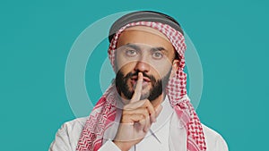 Arabic person makes quiet signal