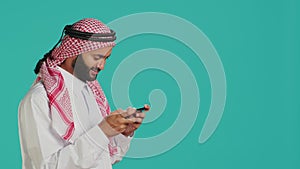Arabic person playing mobile videogames
