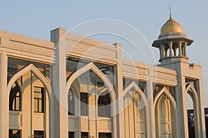 an arabic style building in a sunset against blue