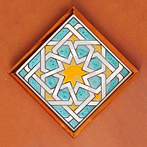 Arabic style tile made using the dry rope (cuerda seca) technique photo