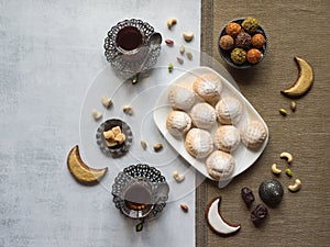 Arabic sweets celebration Eid Ramadan. Egyptian cookies `Kahk El Eid` and tea cups.