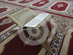 Quran on elegant Persian rugs - the Arabic text with English translation.