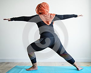 Arabic woman doing yoga in her room