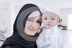 Arabic woman and her son at home