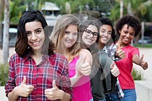 Arabic woman showing thumb with group of girlfriends