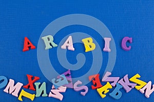 ARABIC word on blue background composed from colorful abc alphabet block wooden letters, copy space for ad text. Learning english