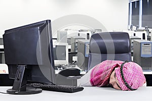 Arabic worker sleeping in the office