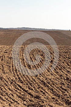 Arable field. Plowed agricultural arable land.