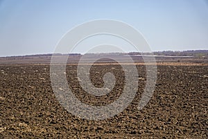 Arable land in spring against the blue sky