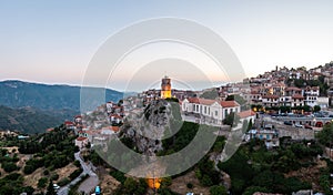 Arachova Greece mountain town aerial drone view. Traditional houses in the evening