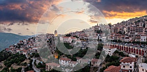 Arachova Greece mountain town aerial drone view. Traditional houses at sunset